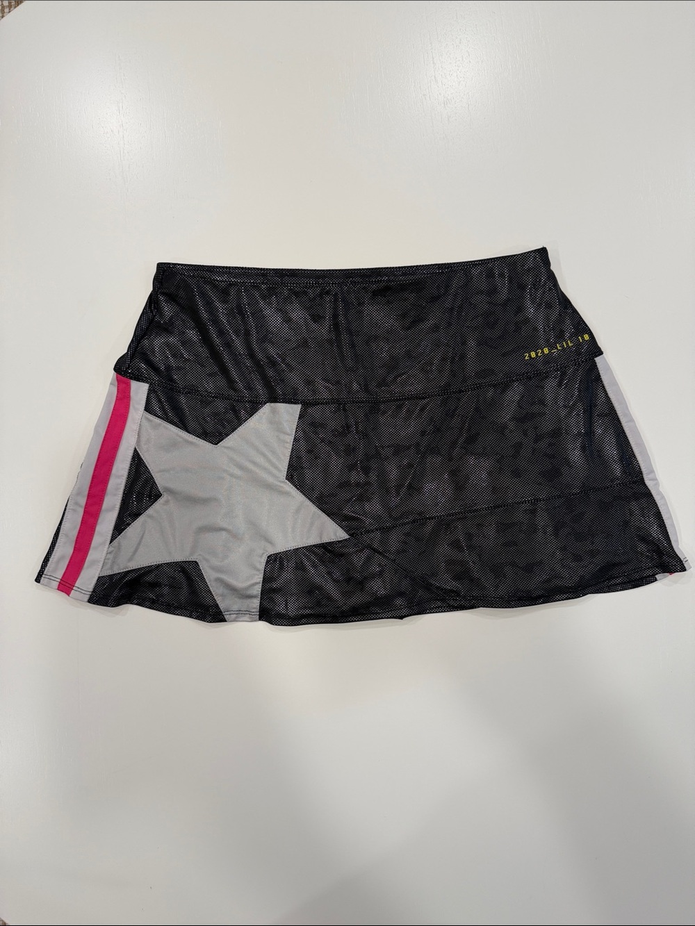 Lucky in Love Tennis Skirt. Black Star-Accent Skirt with Pink Stripe